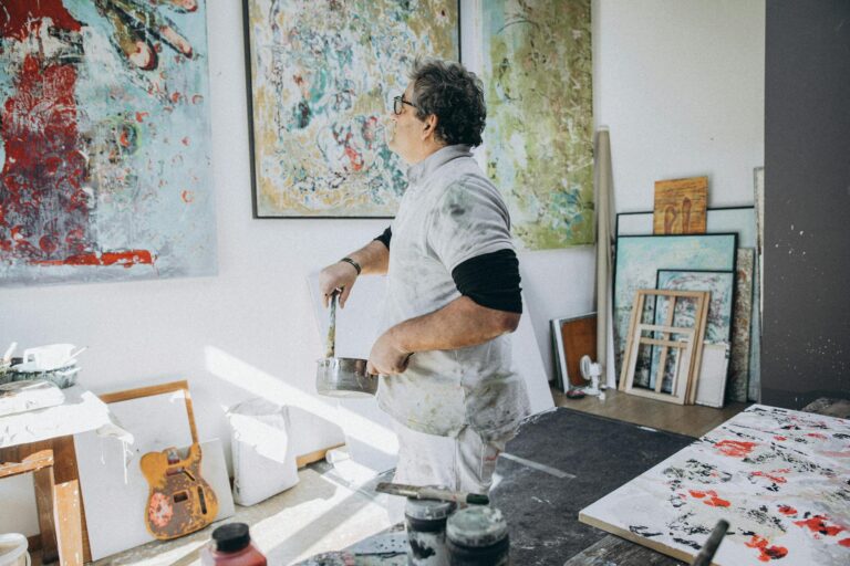 Man Painting on Canvas in a Studio